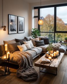 a living room filled with lots of furniture next to a large window covered in candles