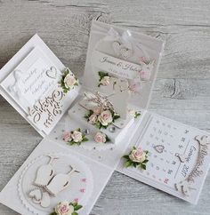 some cards and magnets are laying on a table together, with flowers in the middle