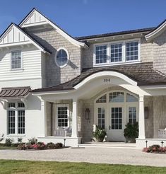 a large house with white trim and windows