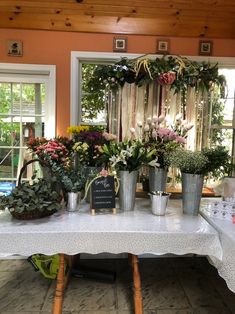 a table topped with lots of potted plants