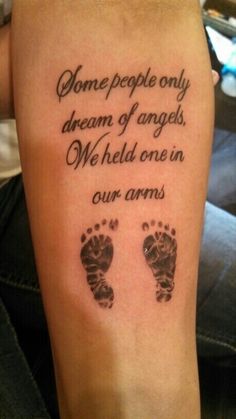 a person with a tattoo on their arm that says, some people only become angels we held one in our arms