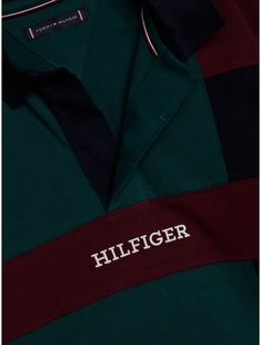 Tommy Hilfiger boys' polo. The varsity-inspired colorblock design adds a sporty touch to this pure cotton polo shirt, finished with a contrast collar and the Hilfiger monotype logo. Part of our Adaptive Collection, designed for ease of dressing in classic Tommy style.  Material: 100% Transitional Cotton ,  In-conversion. Green Cotton Polo Shirt With Ribbed Collar, Sporty Collared Polo Shirt With Logo Print, Sporty Cotton Polo Shirt With Logo Print, Collegiate Cotton Polo Shirt With Short Sleeves, Collegiate Cotton Short Sleeve Polo Shirt, Sporty Cotton Polo Shirt With Collared Neckline, Green Cotton Sporty Polo Shirt, Green Sporty Cotton Polo Shirt, Sporty Green Cotton Polo Shirt