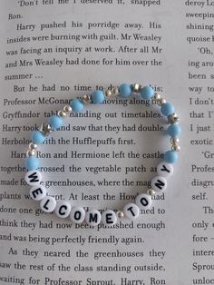 a blue and white bracelet with words written on it that says welcome to the family