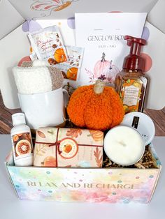 a gift box with candles, soaps and other items in it on a table