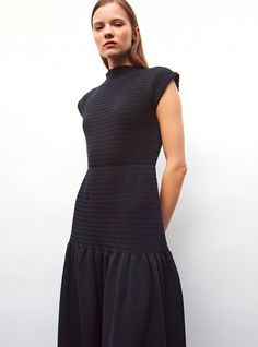 This smocked, long knit dress is made in France from pure extra-fine virgin wool and stretch cotton yarns. Its smocked knit bodice and nipped-in fit will flatter any silhouette. Its invisible waistband creates a peplum effect that unfurls into a ravishing full skirt. In a deep navy blue “night” color, this luxurious knit dress can be worn in any season, either accessorized with gold jewelry for summer or worn with leather boots in the winter. the model is 1m78 tall and wears a size s. Jewelry For Summer, Long Knit Dress, Pull Bebe, Long Knitted Dress, Deep Navy Blue, Blue Night, Long Knit, Full Skirt, Cotton Yarn