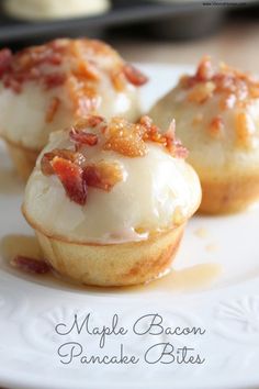 three cupcakes on a white plate topped with bacon