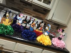 a kitchen counter with mickey mouse decorations and wine bottles