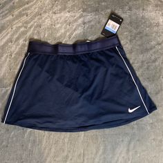 Size Medium New, Never Worn Navy Blue Nike Tennis Skirt Nike Casual Sports Skirt, Casual Nike Sports Skirt, Sporty Nike Skirt For Sports, Sporty Blue Mini Tennis Skirt, Nike Blue Skort For Spring, Blue Sporty Mini Skort, Sporty Blue Mini Skort, Sporty Blue Skort, Blue Mini Skort For Sports