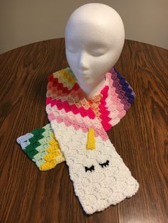 This sleepy unicorn is soft and full of color.  It is crocheted from acrylic yarn. Unicorn Scarf, Mini Christmas Stockings, Louisville Ky, Rainbow Unicorn, Pansies, Hand Warmers, Acrylic Yarn, Scarf Wrap, Christmas Stockings