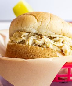 a chicken salad sandwich sitting in a basket