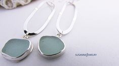 Find a gift she'll cherish. Timeless jewelry for every occasion. Our sterling silver and sea glass dangle earrings feature a long, slender modern design. OOAK pieces of surf tumbled sea glass are first chosen to coordinate, then carefully wrapped in fine silver bezel wire with an eye-catching polish. Each lengthy oval of sterling wire is shaped and hammered by artisan Susan Volger. There is a lot of movement in these earrings and they are very comfortable to wear. They dangle from a pair of ster Handmade Silver Earrings With Sea Glass, Silver Recycled Glass Earrings For The Beach, Beach Earrings In Silver With Recycled Glass, Beach Silver Earrings With Recycled Glass, Silver Sea Glass Earrings For Gift, Handmade Silver Sea Glass Earrings, Elegant Silver Sea Glass Earrings, Elegant Sea Glass Dangle Earrings, Silver Recycled Glass Beach Earrings