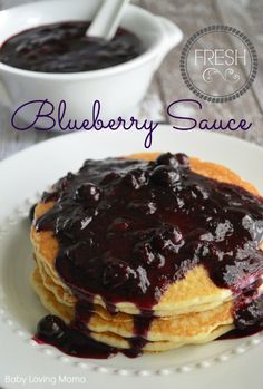 a stack of pancakes with blueberry sauce on top