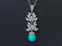 Wedding Teal Colored Turquoise Pearl CZ Silver Cluster Bridal Pendant Necklace with .925 Sterling Silver Chain. PLEASE READ ITEM DESCRIPTION before placing your order, and contact me with any questions! CHAIN is 18 inches (45.7cm) long. PENDANT is about 1.45 inch (3.7cm) long including bail. BRIDAL NECKLACES SECTION: https://www.etsy.com/shop/LanaChayka?ref=seller-platform-mcnav§ion_id=11638944 NECKLACES SECTION: https://www.etsy.com/shop/LanaChayka?ref=seller-platform-mcnav§ion_id=17026331 Eleg Turquoise Pendant Jewelry For Wedding, Elegant Turquoise Bridal Necklace For Wedding, Elegant Turquoise Teardrop Pendant Drop Necklace, Luxury Turquoise Teardrop Pendant Necklace, Nickel-free Elegant Turquoise Necklace, Elegant Nickel-free Teardrop Turquoise Necklace, Luxury Silver Turquoise Necklace, Elegant Style, Bridal Pendant Necklace, Teal Jewelry