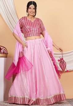 Readymade Faux Georgette Lehenga. This attire with Poly Shantoon, Can Can and Cotton Lining is Enhanced with Dangles, Potli Bag, Pocket, Zari, Sequins and Gota Lace Work. Available with a Faux Georgette Choli and a Faux Georgette and Net Dupatta. Crafted in Sweetheart Neck and Half Sleeve. The Choli and Lehenga Length is 15 and 42 inches respectively.   Do note: Accessories shown in the image are for presentation purposes only. Slight variation in actual color vs. image is possible.          We Pink Skirt Set With Dupatta For Festive Occasions, Festive Pink Skirt Set With Dupatta, Festive Pink Skirt Set With Unstitched Blouse, Pink Sequined Sets For Celebration, Pink Sequin Sets For Celebration, Pink Sequined Celebration Sets, Pink Zari Work Skirt Set For Festive Occasions, Pink Skirt Set With Zari Work For Festive Occasions, Festive Pink Skirt Set With Zari Work