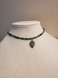 A beaded choker made of various shades of green glass beads and a glass leaf charm that has a bronze tone.  The beaded part of necklace is 14in and has a 2in extending chain. The beads are do not follow a specific pattern so they will vary with each necklace. Green Czech Glass Beaded Necklace With Dangling Beads, Earthy Necklace, Earthy Jewelry, Saint Michael, Hippie Necklace, Funky Jewelry, Jewelry Lookbook, Forest Fairy, Beaded Choker Necklace