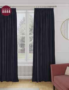 a living room filled with furniture and a window covered in blue drapes next to a red chair