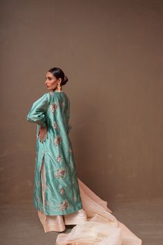 A ferozi colored, raw silk shirt with floral hand-embroidery and a net, organza pearl white dupatta and raw silk ajar pants.3-Piece SuitReady to wear Spring Silk Embroidered Anarkali Set, Spring Embroidered Silk Anarkali Set, Designer Silk Sharara With Floral Embroidery, Silk Floor-length Palazzo Set With Floral Embroidery, Silk Sharara With Floral Embroidery For Eid, Silk Anarkali Set With Zari Work For Spring, Eid Silk Sharara With Floral Embroidery, Spring Raw Silk Palazzo Set With Straight Kurta, Spring Palazzo Set In Raw Silk With Straight Kurta