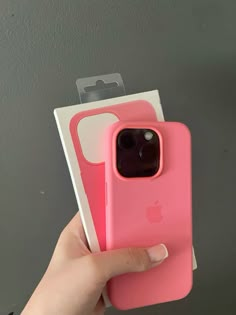 someone is holding up their pink iphone case in front of the camera and packaging it