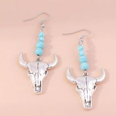 Shine Bright Like A Rodeo Star With These Turquoise Bull Skull Drop Earrings. Woven With A Combination Of Faux Turquoise And Silver Toned Bull Skull, These Unique Earrings Will Bring A Classic Western Charm To Any Ensemble. Perfect For Cowgirls, Rodeo Performers And Festival Goers Alike, These Beautiful Earrings Are Sure To Add A Fashionable And Stylish Touch To Any Outfit. Be The Standout At Your Next Event With Silver Western Cowgirl Turquoise Bull Skull Drop Earrings. Fishhook Style Brand New Cowgirl Turquoise, Pineapple Jewelry, Pewter Earrings, Boho Drop Earrings, Jewelry Western, Faux Pearl Earrings, Bull Skull, Snake Earrings, Bull Skulls