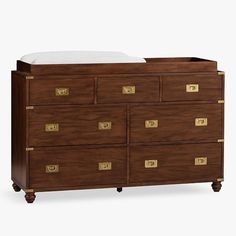 the dresser is made from wood and has gold hardware on it's drawers, which are