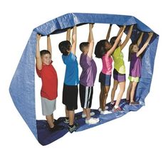 several children are playing on a trampoline with their hands up in the air