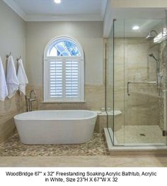 a bathroom with a tub, shower and window