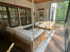 a porch swing bed with pillows on it