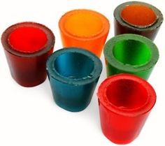 several different colored cups sitting next to each other