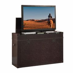 a flat screen tv sitting on top of a wooden box