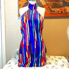 This Beautiful Sexy Dress Is A Size Large, And Backless. Very Nice Colors, Stretchy And Form Fitting. Fits More Like An Extra Large Length Is 38 Inches From Neck Line Multicolor Stretch Dress For Club, Multicolor Halter Neck Bodycon Dress For The Beach, Multicolor Halter Neck Club Dress, Sleeveless Multicolor Bodycon Dress For Date Night, Multicolor Halter Neck Bodycon Dress For Beach, Halter Neck Multicolor Club Dress, Multicolor Bodycon Mini Dress For Vacation, Blue Sleeveless Flirty Halter Dress, Blue Halter Neck Bodycon Dress For Club