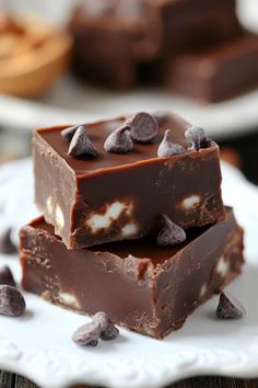 two pieces of chocolate fudge on a white plate