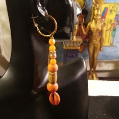 Chic Small Top Gold Tone Latch Backs Hoops With Bottom Orange Beaded Lucite Beads, Orange Wood Beads And Bottom Orange Painted Cowrie Shells Earrings. Earrings Are 3 1/2. Inches In Length Light Weight And Not Heavy. Gold Tone Latch Back Ear Wires Are Hyproallegic Metal Lead Free/Nickle Free Ear Wires. Traditional Orange Earrings For Beach, Bohemian Orange Earrings With Gold Beads, Orange Beaded Earrings With Gold Round Beads, Orange Dangling Beads Earrings For Beach, Orange Beaded Dangling Earrings For Beach, Orange Jewelry With Dangling Beads For Beach, Orange Beach Jewelry With Dangling Beads, Small Hoops Earrings, Shells Earrings