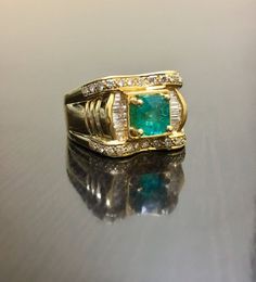 DeKara Designs ClassicHandmade Art Deco Oval Emerald and Diamond Ring.This ring was entirely handmade, anyone lucky enough to buy this ring will truly appreciate the workmanship and the beauty of this piece of art.Metal- 18K Yellow Gold, .750.Size- 8.  FREE SIZING!!!!Measurements- Ring is 13.3 MM in the front and tapers down to 4.5 MM in the back.  Stones- 1 Emerald Cut Colombian Emerald 1.00 Carat, 26 Round Diamonds, 14 Baguette Diamonds, F-G Color VS2 Clarity 0.80 Carats.Entirely Handmade Art Emerald Rings With Vvs Clarity For Anniversary, Unique Yellow Gold Emerald Cut Jewelry, Unique Emerald Cut Yellow Gold Jewelry, Unique Emerald Cut Emerald Ring, Unique Emerald Ring With Diamond For Formal Occasions, Unique Hallmarked Emerald Ring For Wedding, Unique Hallmarked Emerald Wedding Ring, Unique Emerald Wedding Ring, Hallmarked, Unique Emerald Cut Emerald Ring For Anniversary