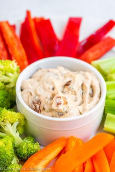 a white plate topped with carrots and broccoli