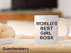 a white coffee mug with the words world's best girl boss next to it