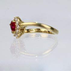 A wonderful cocktail ring by Kurt Wayne.  In 18K yellow gold with a half-twist to the shank. The shank supports a gallery with a central pear-cut ruby and 10 small round cut diamonds.   A high-level ring from the famous New York jewelry designer!  Marked to the shank 750 for 18k gold fineness and with a conjoined KW for Kurt Wayne.  Ring Size: ca. 5 1/2  Dimensions reference the ring size and are not specific to the ring itself. Yellow Gold Ruby Ring With Prong Setting, Pear-shaped Ruby Ring In Yellow Gold With Prong Setting, Pear-shaped Brilliant Cut Yellow Gold Ruby Ring, Pear-shaped Gold Ruby Ring With Diamonds, Pear-shaped Ruby Diamond Ring In Gold, Elegant Pear-shaped Ruby Ring In Yellow Gold, Elegant Pear-shaped Yellow Gold Ruby Ring, Elegant Pear-shaped Ruby Ring With Center Stone, Pear-shaped Yellow Gold Ruby Ring With Center Stone