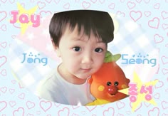 a young boy holding a stuffed animal in front of a heart - shaped frame with the words joy on it