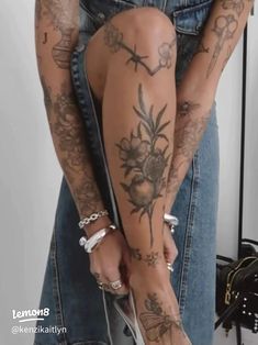 a woman with tattoos on her legs holding a purse