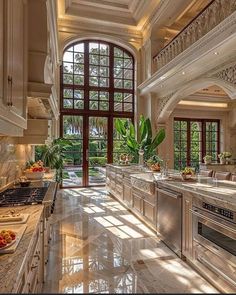 a large kitchen with marble counter tops and an arched doorway leading to the second floor