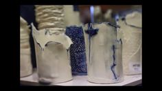 several white vases with blue designs on them