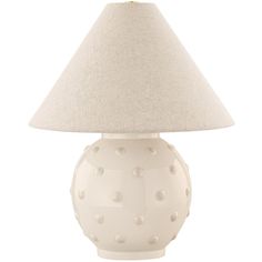 a white table lamp with a beige shade on it's base and polka dot print lampshade