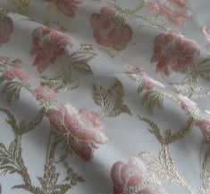 the fabric has pink and gold flowers on it