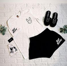 🚨 PLEASE READ CAREFULLY * The slippers that are part of the set are GRAY with Black design. BAD BUNNY PAJAMAS SET: True black pajamas with white piping for a minimalistic and timeless look. Pajamas set made of 65% polyester and 35% cotton. Perfect blend for added comfort!! Also available in white with black piping! 📌 While most find items to run true to general t-shirt sizing, some customers recommend going up one size for a better fit. 🚨Pajamas Set sizing is as follows: 📌Small: 1. Bust: 33. Bunny Pjs, Bad Bunny Birthday, Bunny Pajamas, Bunny Hoodie, Black Pajamas, Bunny Birthday, Cotton Sleepwear, Bunny Shirt, Bunny Designs