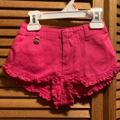 Pink Shorts With Ruffles Around The Bottom, Elastic In The Back, A Rl Metal Tag That Hangs From The Front Belt Loop With A Green Polo Pony Logo Above The Back Pocket. Size 12 Months. 100% Cotton. Nwt Cute Fitted Bottoms For Playwear, Cute Ruffled Bottoms For Playwear, Casual Ruffle Bottoms For Playwear, Casual Ruffled Bottoms For Playwear, Trendy Short Bottoms For Playwear, Trendy Cotton Playwear Bottoms, Trendy Cotton Bottoms For Playwear, Fitted Ralph Lauren Bottoms For Summer, Pink Ruffled Cotton Bottoms