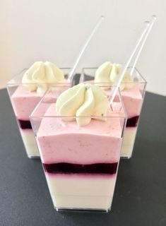 three desserts in small glass containers on a table