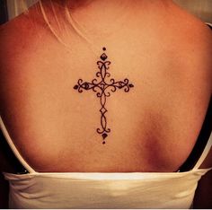 a woman with a cross tattoo on her back