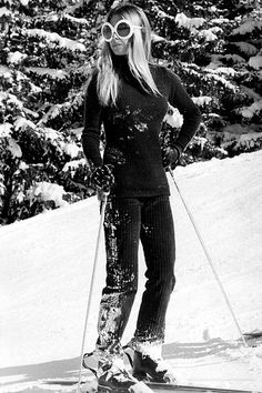 a woman is standing on skis in the snow