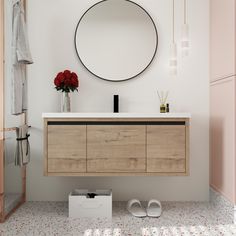 a bathroom with a round mirror above the sink and shoes on the floor next to it