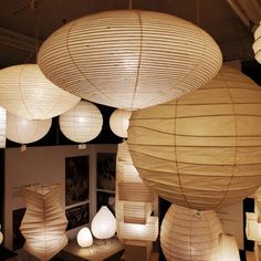 many paper lanterns are hanging from the ceiling