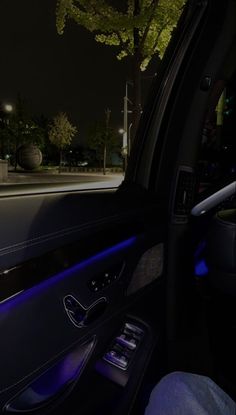 the interior of a car at night with blue lights